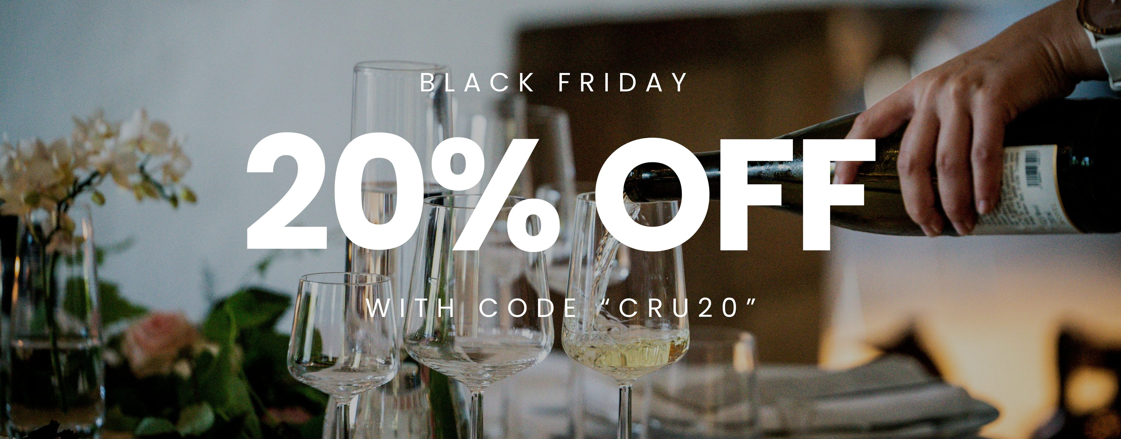 Black Friday sale promotion with wine glasses and a blurred background